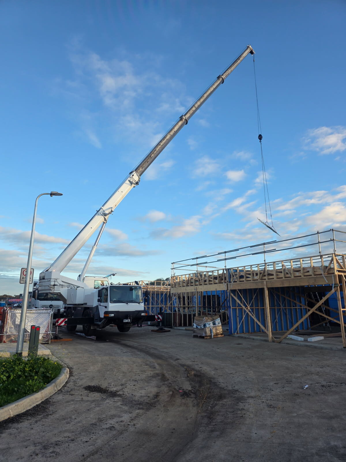 40t Liebherr crane lifting a plant unit onto a home