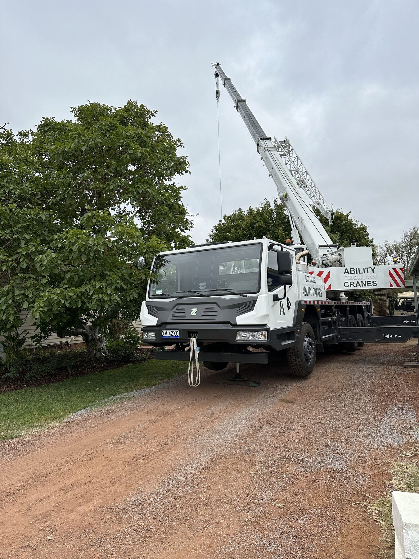Slew crane set up in a residential driveway